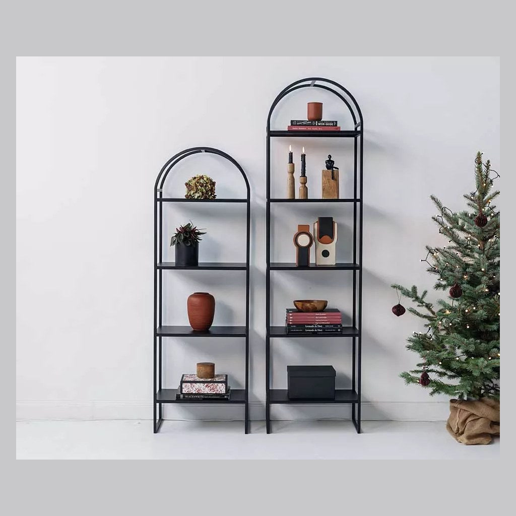 Estantería Arcus Kallfü negra decorada con libros, vasijas y objetos en un ambiente moderno