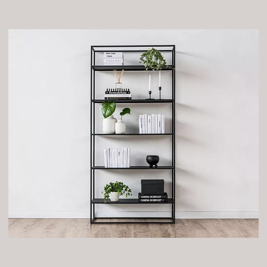 Estantería Simplex Kallfü negra de 90 cm ambientada en un living con libros y plantas